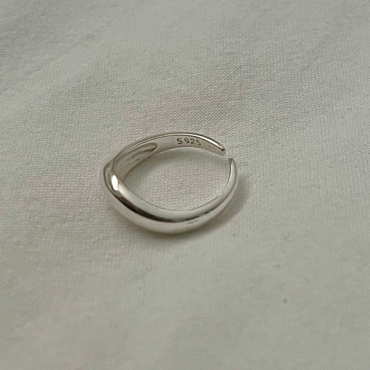 Silver ring on a light gray fabric background