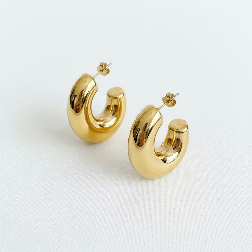 Gold hoop earrings on a white background