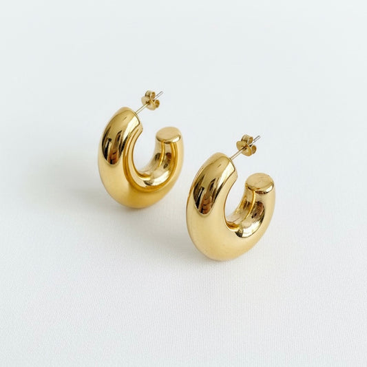 Gold hoop earrings on a white background