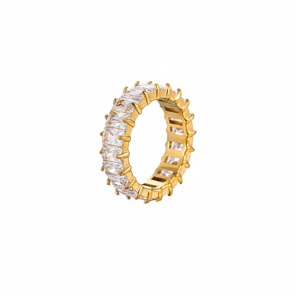 Gold ring with clear gemstones on a white background
