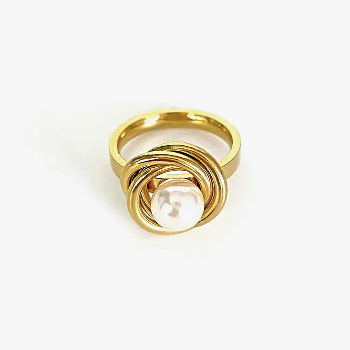 Gold ring with a pearl on a white background