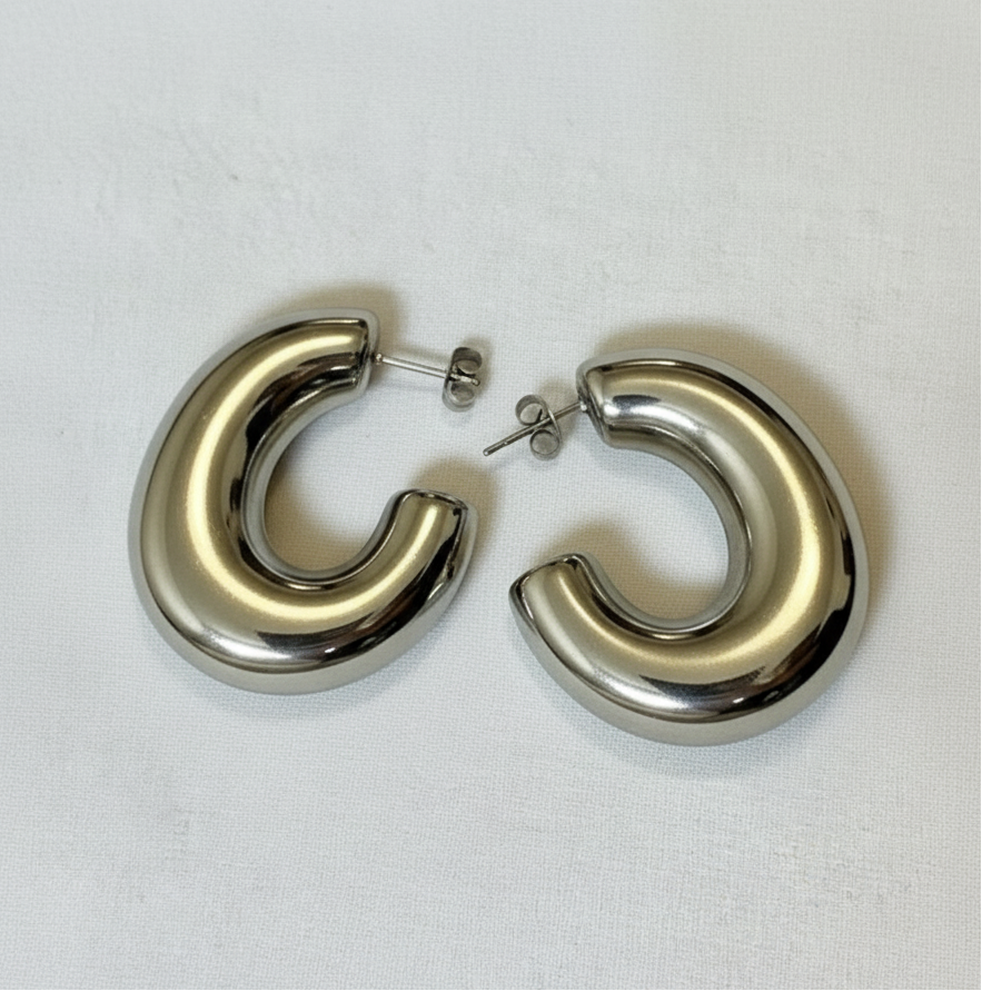 Pair of silver hoop earrings on a light gray background