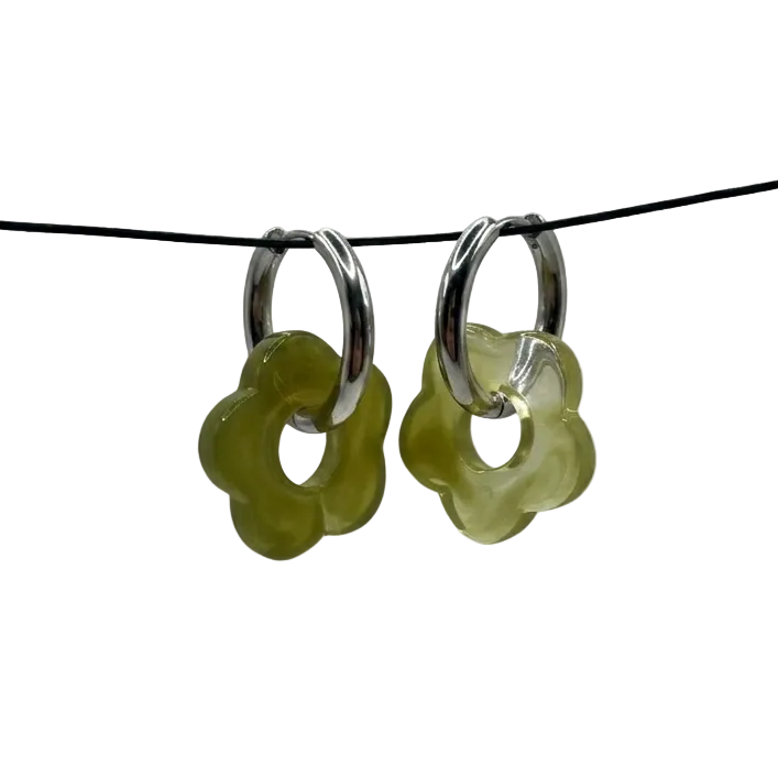 Pair of silver hoop earrings with green floral charms on a thin black wire against a light gray background.