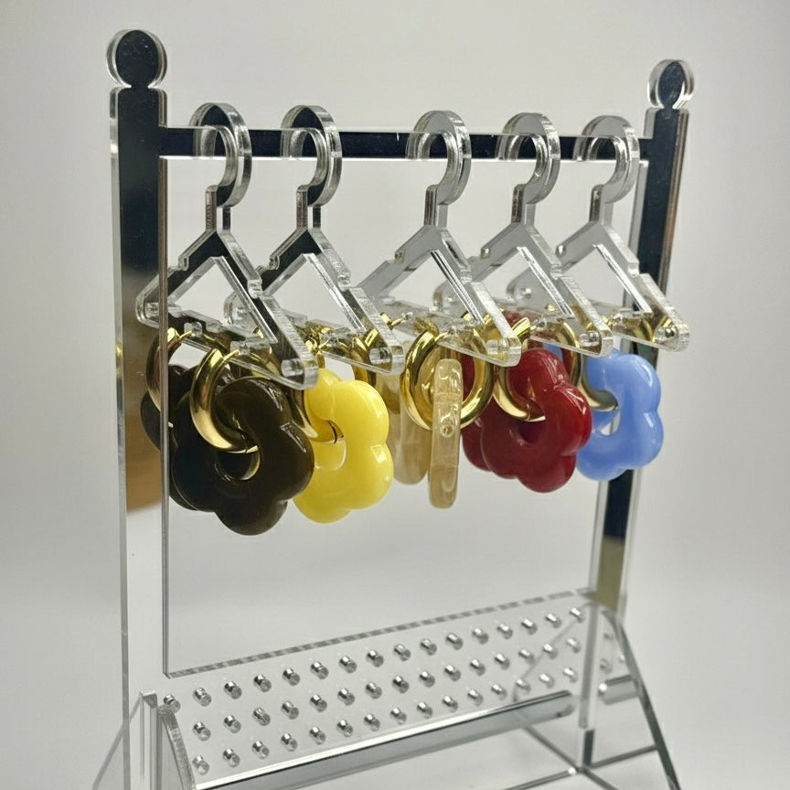 Metal hanger display with colorful keychains on a white background
