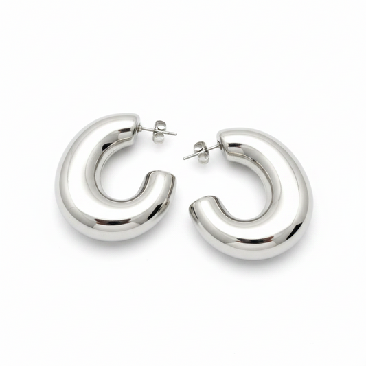 Pair of silver hoop earrings on a light gray background