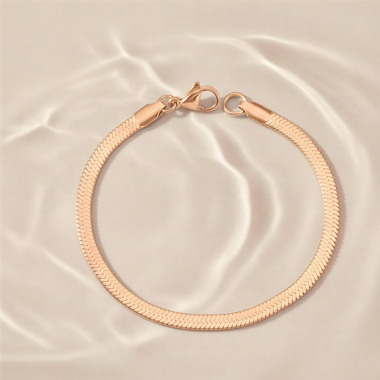 Rose gold bracelet on a beige satin background