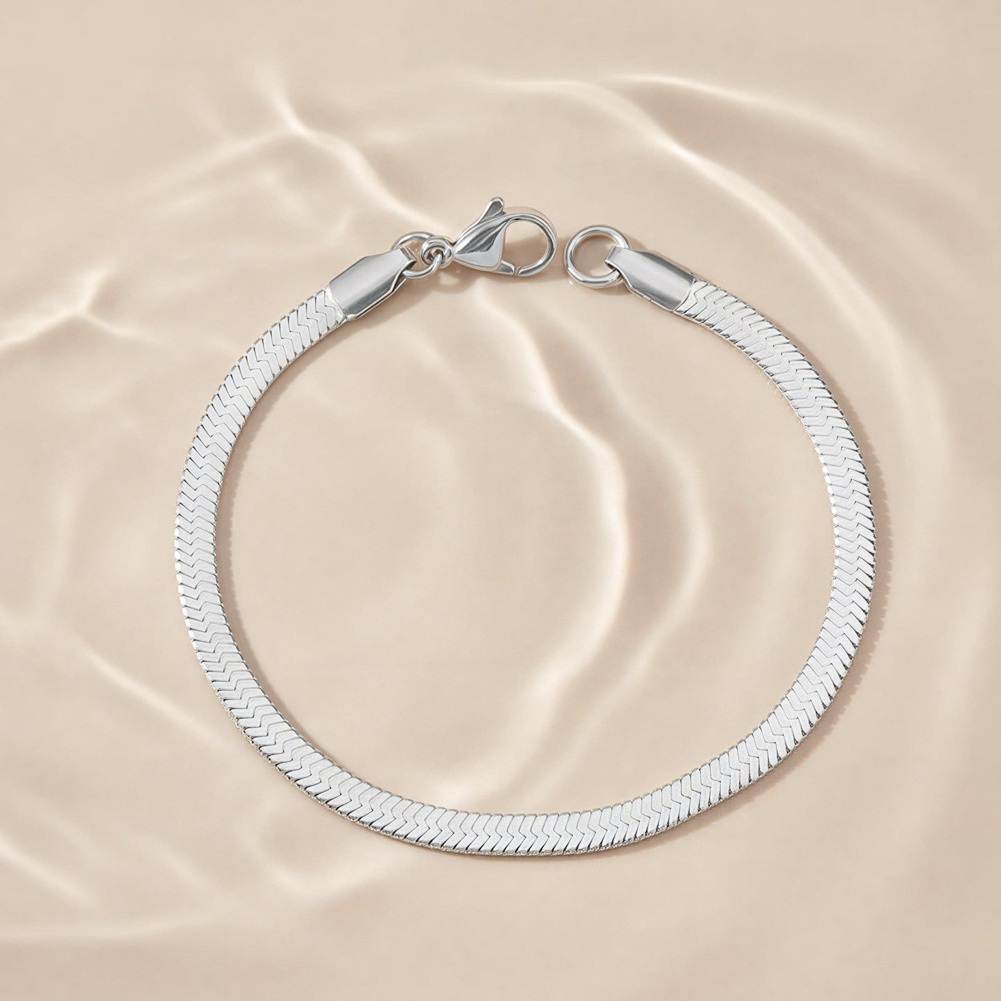 Silver bracelet on a beige fabric background