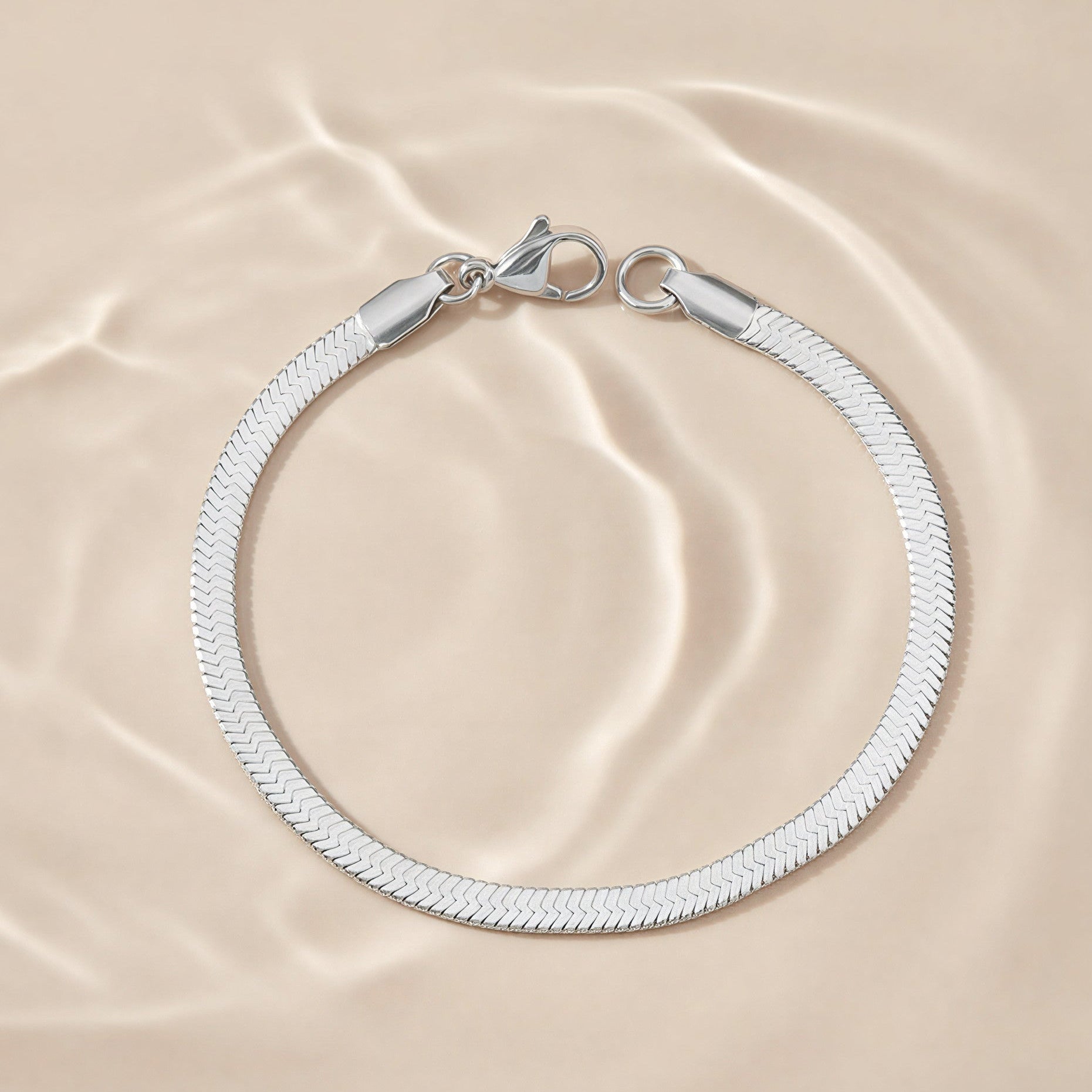 Silver bracelet on a beige fabric background