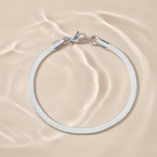 Silver bracelet on a beige fabric background