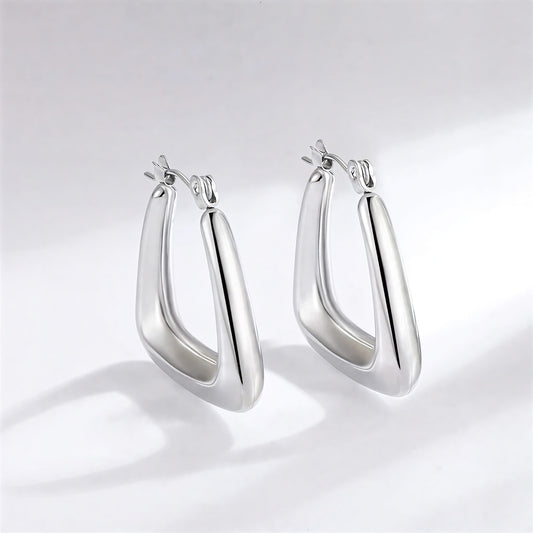 Pair of silver hoop earrings on a light gray background