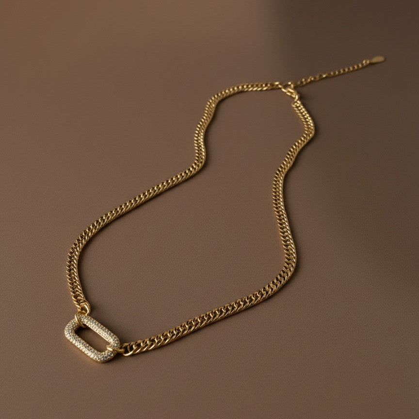 Gold chain necklace on a brown background