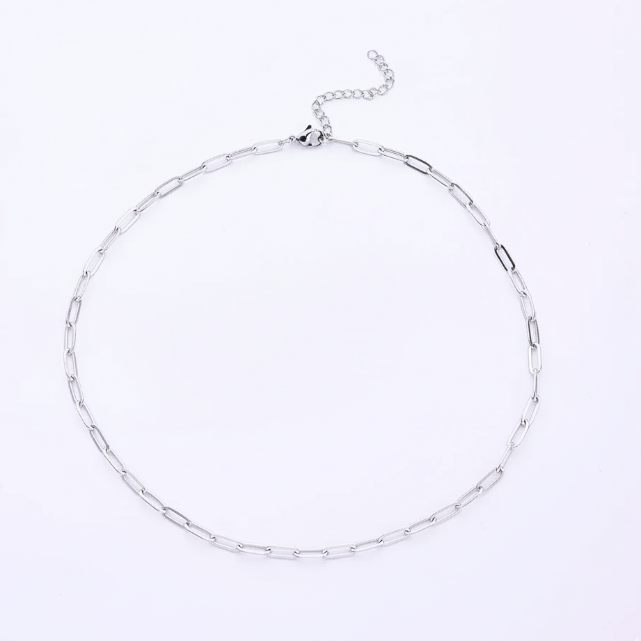 Silver chain necklace on a light purple background